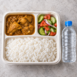 Affordable workforce meal with rice chicken curry salad and water UAE